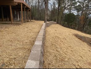 services retaining rock wall on steep hillside landscaping and wall by LawnScapes